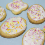 easter egg shaped biscuits with white icing and pastel sprinkles