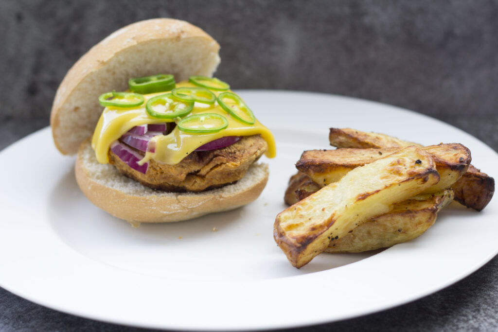 Homemade Salt and Pepper Wedges - Oven Cooked or Air Fryer 101 Homemade Salt and Pepper Wedges on the side of a vegan burger
