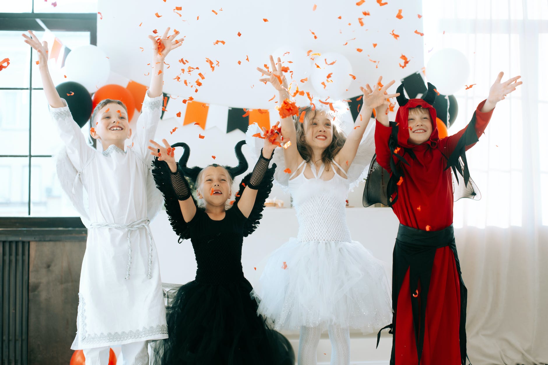 children in halloween costumes having fun celebrating the party