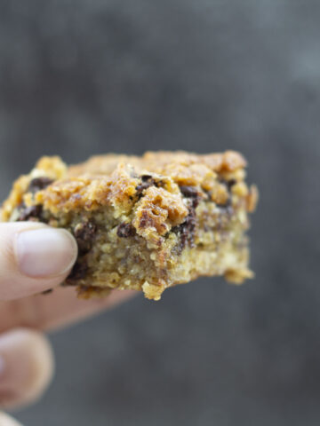 a hand holding a vegan blondie