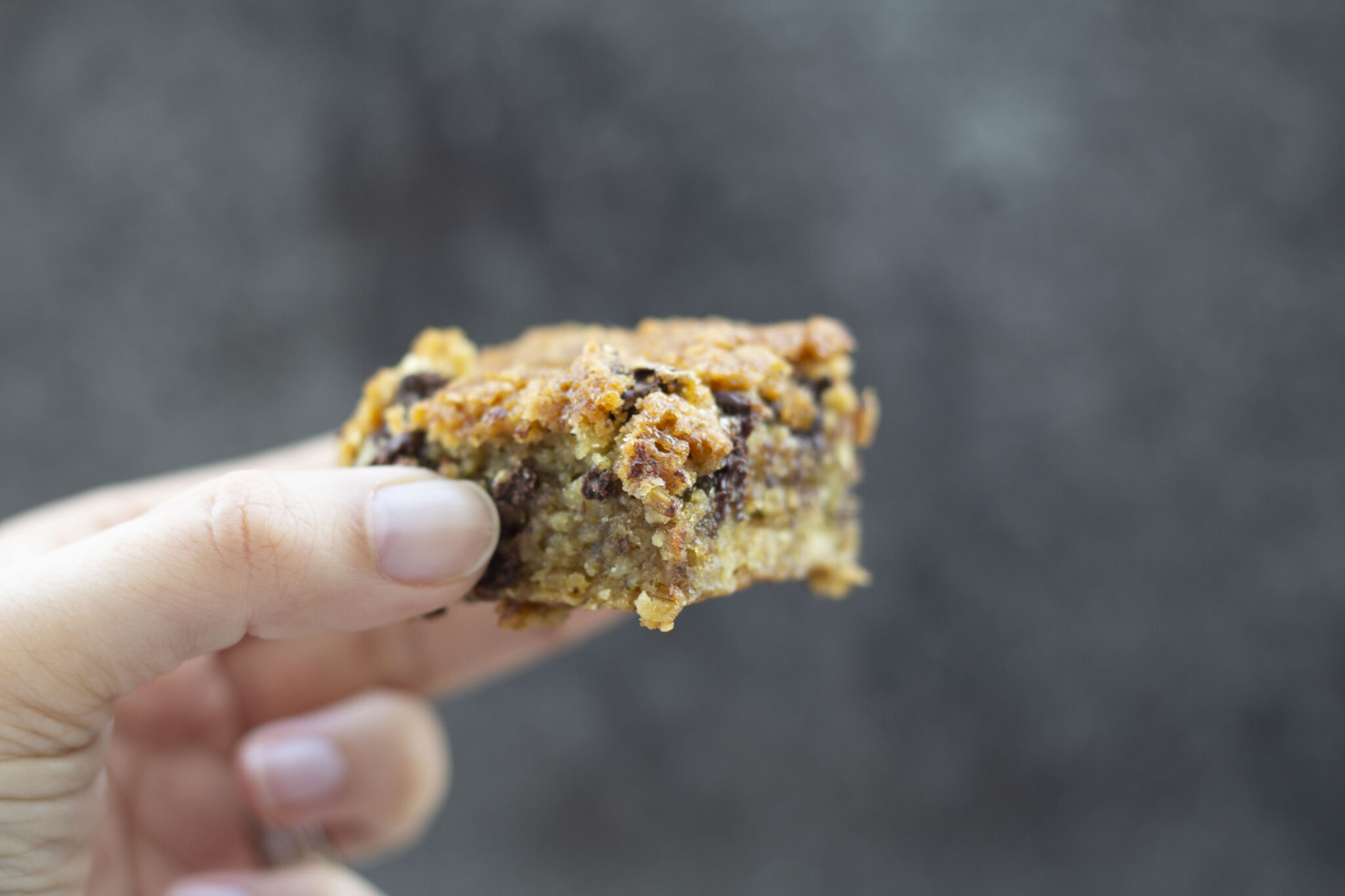 a hand holding a vegan blondie
