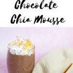 A rich vegan chocolate mousse in a small glass topped with whipped cream and sprinkles