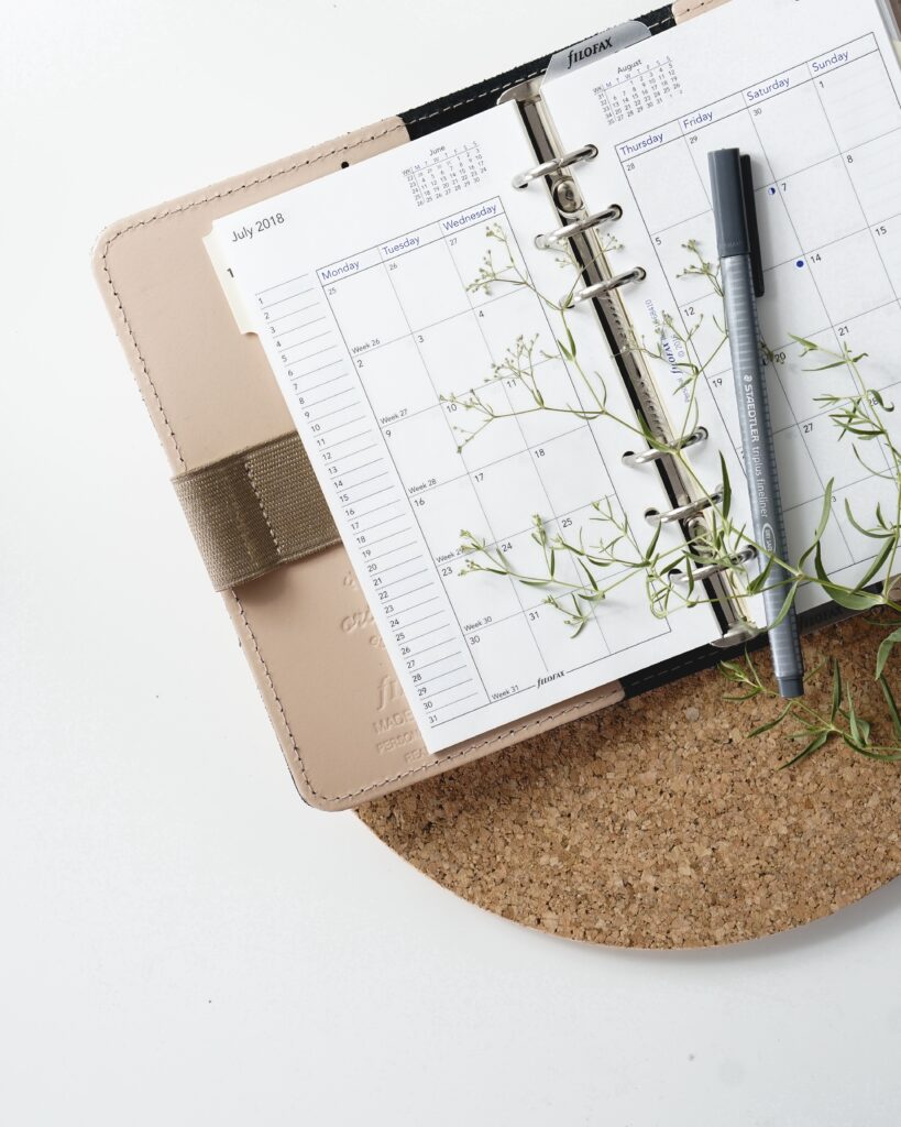 Free Weekly Family Vegan Meal Plan (PDF) 3 an open diary with a pen resting on top.
