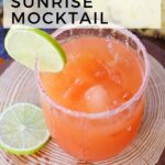 A glass of tequila sunrise mocktail with ice, garnished with a lime slice on the rim and another lime slice on a wooden surface. Text above reads "We Made This Vegan Tequila Sunrise Mocktail." Enjoy our refreshing twist on the classic tequila sunrise mocktail!