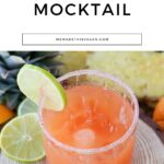 A glass of Tequila Sunrise mocktail with a salted rim, brimming with a vibrant orange beverage and garnished with a lime slice. "Tequila Sunrise Mocktail" text above.