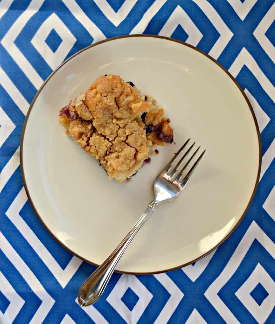 30 Delicious Vegan Blueberry Dessert Recipes 10 Slice of vegan blueberry coffee cake on a white plate with a fork.