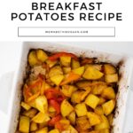 A white baking dish filled with crispy roasted potatoes and bell peppers, captioned "Easy Crispy Roasted Vegan Breakfast Potatoes Recipe." Website link: wemadethisvegan.com. #VeganBreakfastPotatoes