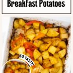 A white dish filled with crispy vegan breakfast potatoes mixed with red and yellow bell peppers, showcasing a golden-brown finish. Text reads "Crispy Roasted Vegan Breakfast Potatoes.