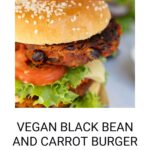 Close-up of a mouthwatering black bean and carrot burger, topped with fresh lettuce and juicy tomato, nestled in a soft bun. Text below reads: "Delicious Black Bean and Carrot Burger Recipe" on wemadethisvegan.com.