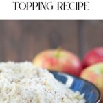 A bowl of easy vegan crumble topping sits on the table, invitingly positioned with apples in the background. Overhead, cheerful text reads, "Easy Vegan Crumble Topping Recipe," setting the stage for a delightful culinary adventure.