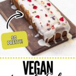 A rectangular Vegan Avocado Cake with lemon icing and colorful flower petals sits on a wooden board. A label says "So pretty!" and the text reads "Vegan Avocado Cake." Try this delicious vegan cake recipe for any occasion!.