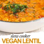 A bowl of vegan lentil soup garnished with fresh herbs, with the text "slow cooker vegan lentil soup recipe" below the image.
