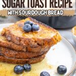 Three slices of cinnamon sugar toast made with sourdough bread, topped with blueberries and syrup, served on a white plate. Text overlay reads: "Best Cinnamon Sugar Toast Recipe you’ll love with Sourdough Bread.