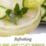 A refreshing cucumber mocktail with ice, mint leaves, and cucumber slices, served in a glass with a sugared rim and a hint of tangy lime.