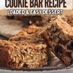 Close-up of chewy oatmeal cookie bars packed with nuts and dried fruit on a plate, with text highlighting this loaded and easy oatmeal cookie bar recipe as your next delicious dessert.
