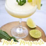 A Summer Melon Margarita Mocktail in a glass, garnished with a lime slice, melon wedge, and mint, with lime halves and mint leaves on the side—an easy recipe perfect for refreshing summer vibes.