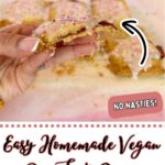 A hand holds a bitten vegan pop tart with pink icing and sprinkles; more are on baking paper in the background. Text reads "Easy Homemade Vegan Pop Tarts Recipe"—the perfect vegan pop tart recipe for any sweet craving.