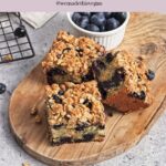 A close-up of a delicious vegan blueberry coffee cake, highlighting its moist texture and fresh berries.