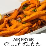 A white dish filled with crispy air-fried sweet potato chips, garnished with herbs, with lemon slices in the background. Text reads "Air Fryer Sweet Potato Chips — perfect for frozen or fresh!.